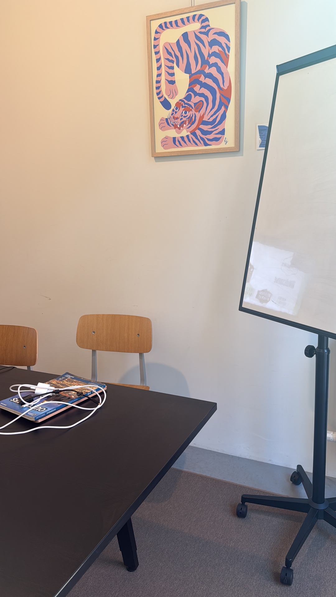 Classroom wall with teaching posters and a whiteboard at English Language Studio Leuven